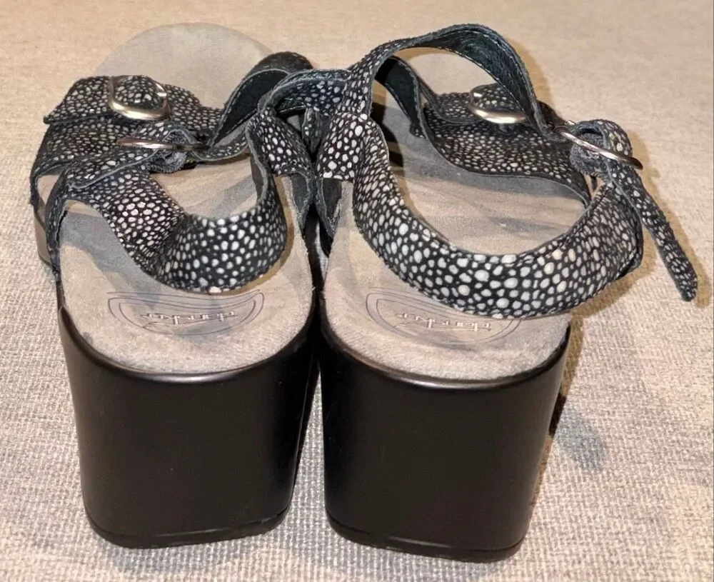 Dansko sandals, specifically the Sandi model featuring a black and white speckle